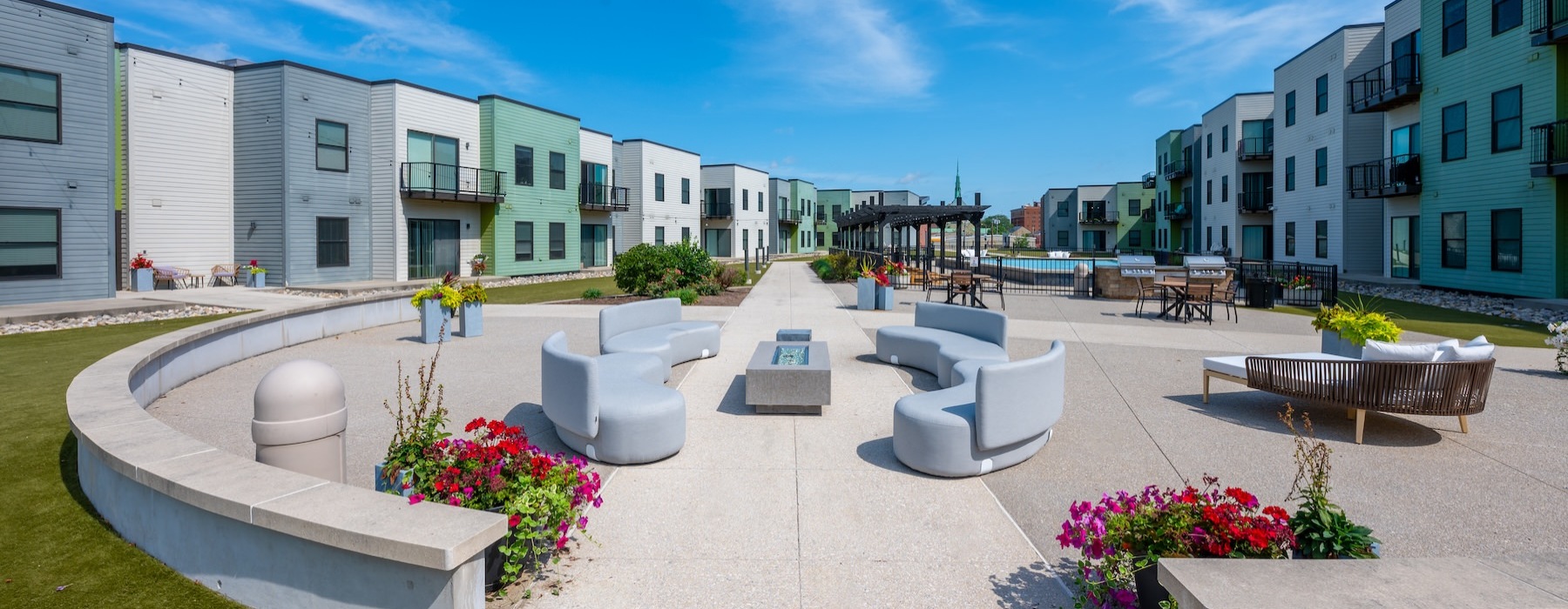 a courtyard with couches, chairs and tables