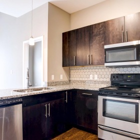 a kitchen with wodden cabinets
