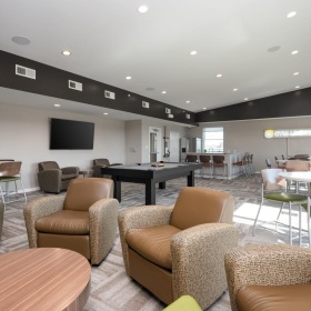a clubroom with chairs and tables